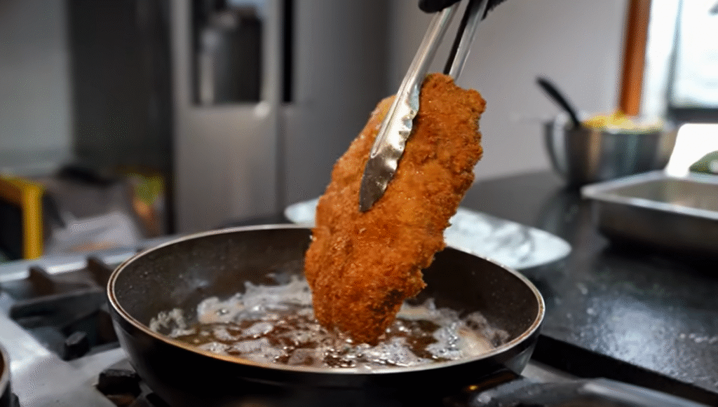 Lionel Messi's Favorite Food Milanesa Napolitana Recipe - Fried done